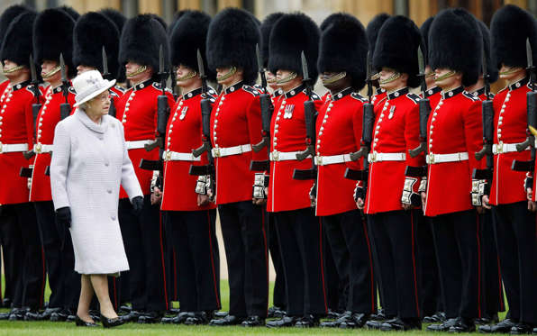 Britain's Queen Elizabeth inspects the guards during the ceremony to present new colours to the 1st Battalion and No. 7 Company the Coldstream Guards at Windsor Castle, England, Thursday May 3, 2012.