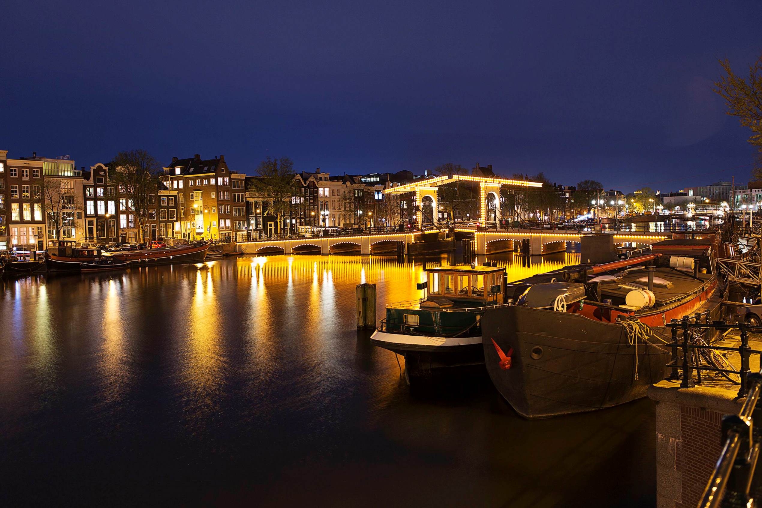 Nightview of the Magere Brug, the skinny bridge,the most famous bridge in Amsterdam April 22, 2013. The Royal celebrations in the Netherlands this week put the country and the capital Amsterdam on front pages and television screens around the world with an orange splash. There's plenty to see and do in 48 hours in this compact city, where the world-famous Rijksmuseum only recently reopened after an extensive renovation. Picture taken April 22, 2013. To match story TRAVEL-AMSTERDAM/ REUTERS/Michael Kooren (NETHERLANDS - Tags: TRAVEL)
