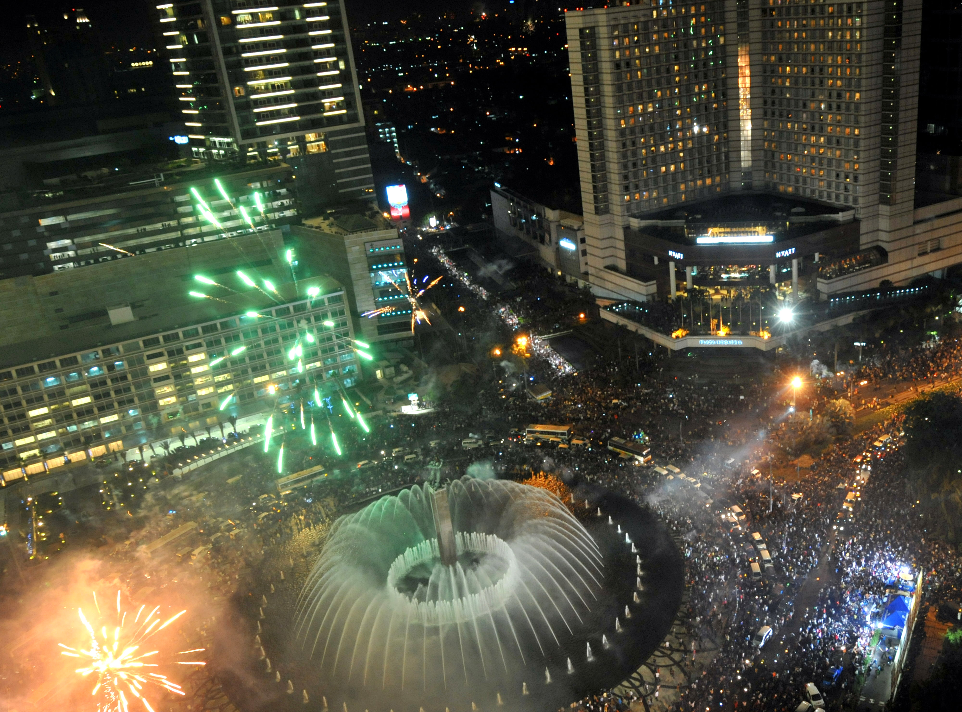 Firewires explode above Jakarta's landmark 'Welcome' statue or Tugu Selamat Datang in Jakarta late December 31, 2008. AFP PHOTO/ADEK BERRY (Photo credit should read ADEK BERRY/AFP/Getty Images)