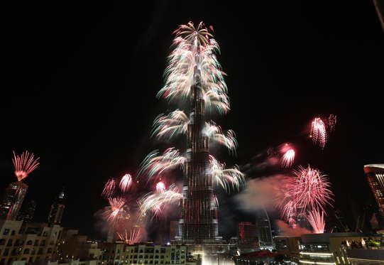 Fireworks explode from the Burj Khalifa, the world's tallest tower, in Dubai on January 1, 2014 to celebrate the new year. Dubai kicked off New Year with a dazzling bid for a new world record to cap those the Gulf city state already holds for its mammoth property developments. The glittering fireworks display that lasted around six minutes spanned over 100 kilometres (60 miles) of the Dubai coast, which boasts an archipelago of man-made islands and Burj Khalifa, the world's tallest tower. AFP PHOTO / STRINGER (Photo credit should read STRINGER/AFP/Getty Images)