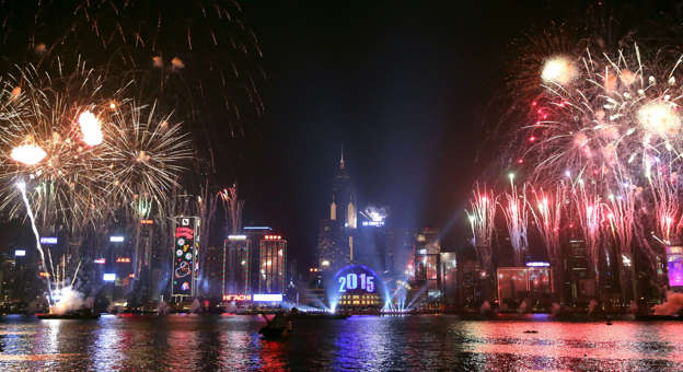 Fireworks explode over Victoria Harbour in Hong Kong on January 1, 2015. Just like previous years, the city's iconic skyline along Victoria Harbour will light up with an eight-minute pyrotechnic display, as tens of thousdands of partygoers will flock to the waterfront to celebrate. AFP PHOTO / ISAAC LAWRENCE (Photo credit should read Isaac Lawrence/AFP/Getty Images)