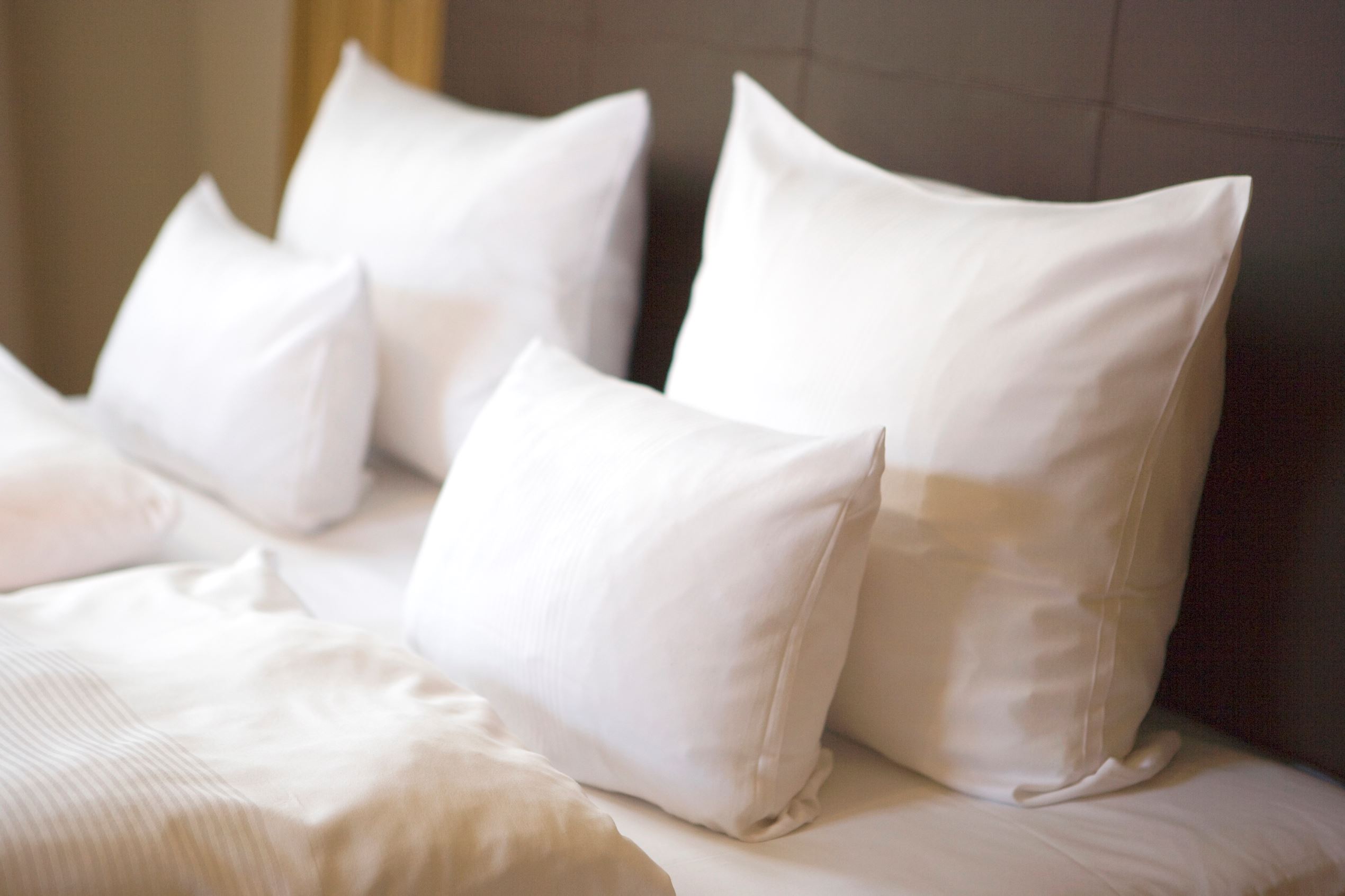 Bed with white pillows, close-up.