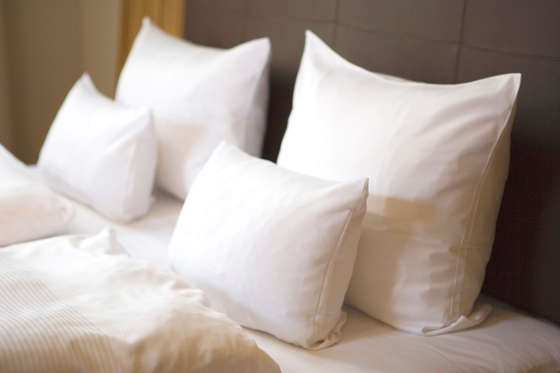 Bed with white pillows, close-up.