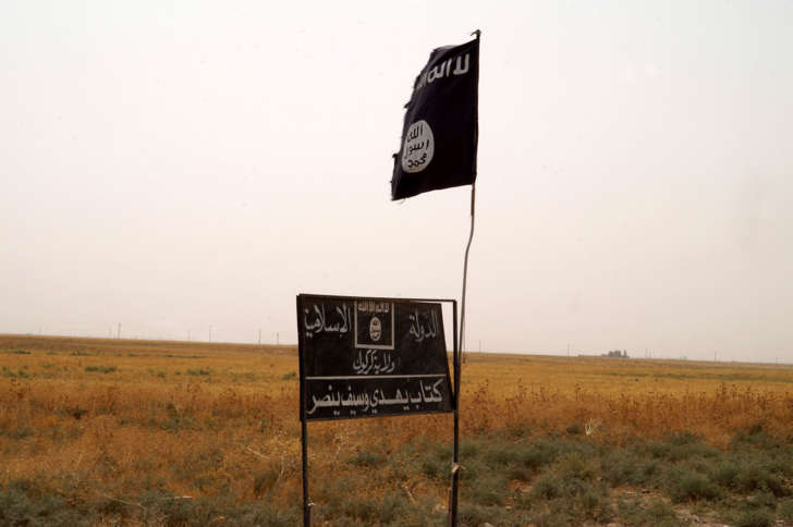 Islamic State group's flag is seen in an area after Kurdish troops known as peshmerga regained control of some villages west of the oil-rich city of Kirkuk, 180 miles (290 kilometers) north of Baghdad, Iraq, Wednesday, Sept. 30, 2015.