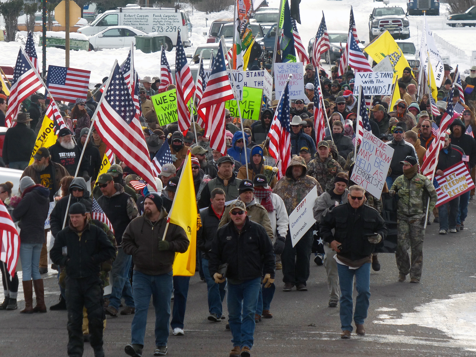 Protesters march on Court Avenue in support of an Oregon ranching family facing jail time for arson in Burns, Ore., Saturday, Jan. 2, 2016.