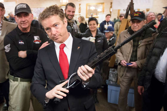 Republican presidential candidate, Sen. Rand Paul, (R-KY),  handles a AR-15 style rifle as he meets with customers during a campaign stop at a gun show at Bektash Shrine Center, Jan. 23, in Concord.