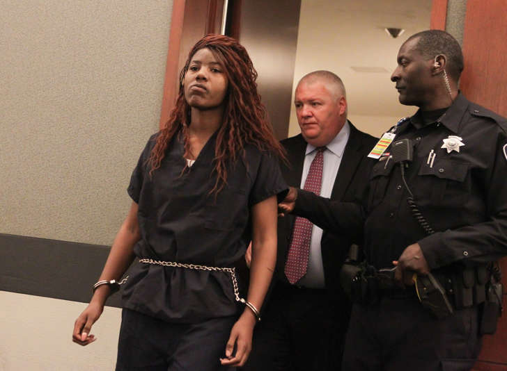 Lakeisha Nicole Holloway enters district court with one of her public defenders, Scott Coffee, for her arraignment Wednesday, Dec. 23, 2015, in Las Vegas. Holloway, who crashed her car into pedestrians on the Las Vegas Strip on Sunday, Dec. 20, has been charged with murder, child abuse and hit-and-run.