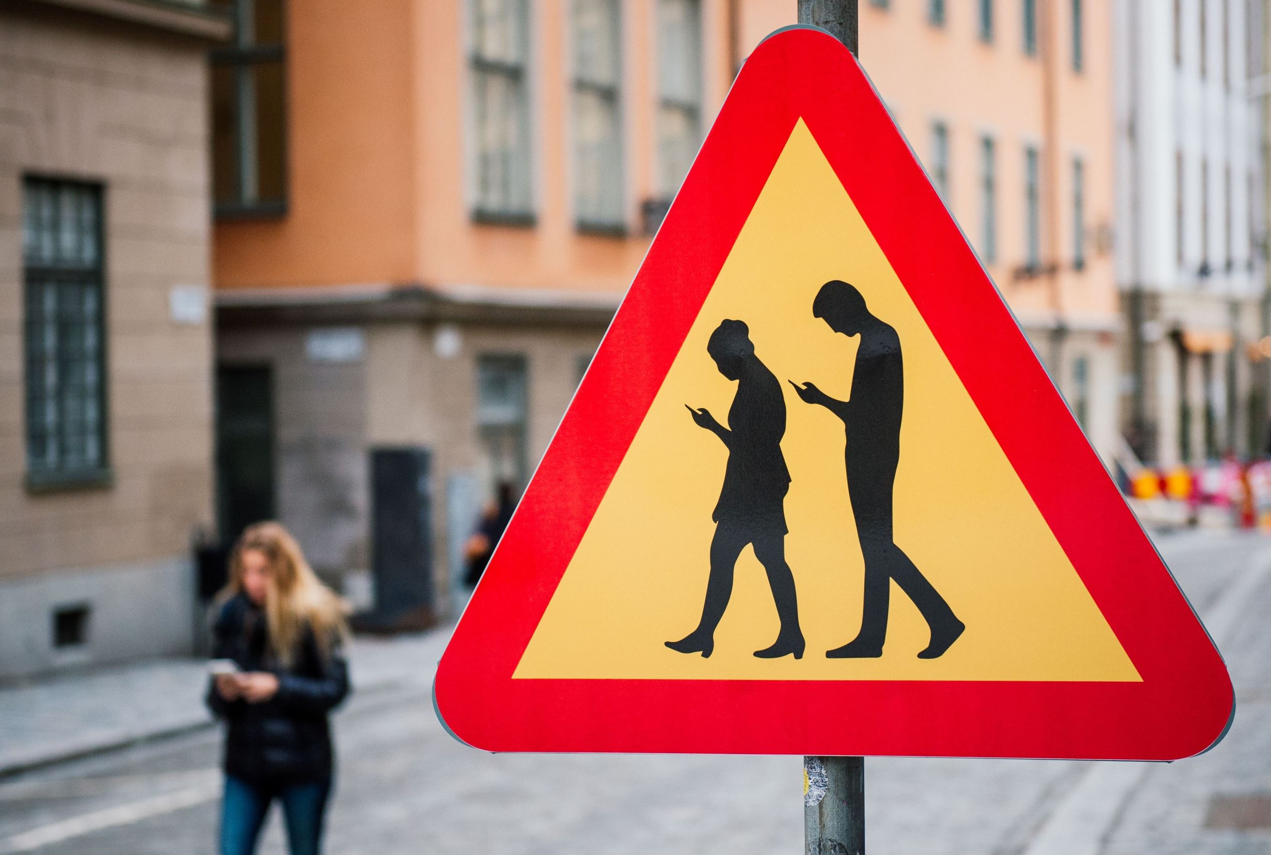 TOPSHOT - A road sign arning against pedestrians focusing on their smartphones is pictured on February 2, 2016 near the old town in Stockholm. / AFP / JONATHAN NACKSTRAND (Photo credit should read JONATHAN NACKSTRAND/AFP/Getty Images)