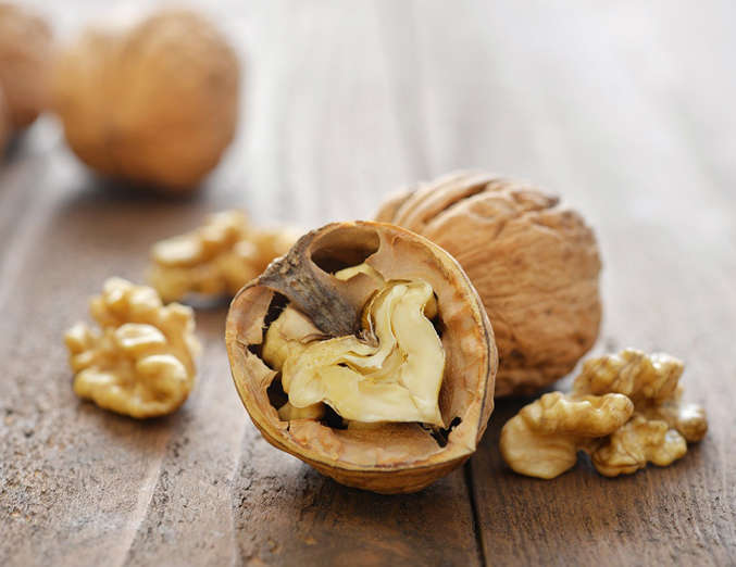 <p>Walnuts are a nutritional double threat: Not only are they one of the best dietary sources of polyunsaturated fats, a type of fat that activates genes that reduce fat storage (see ya, <a href="http://www.eatthis.com/14-ways-lose-your-belly-14-days">belly fat</a>!), they’ve also been shown to improve brain function in mice with Alzheimer's disease. Though we can’t be certain the same would hold true in humans, adding the nut to your diet can only benefit your health, so it's definitely worth a shot. Top your oats and salads with them, or toss some in the food processor and add the mixture to homemade pesto sauces.</p>