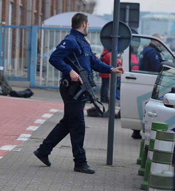 Police officers stand guard around the Zaventem Airport.