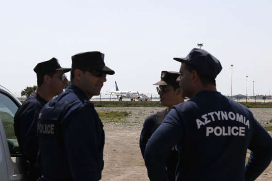 Cypriot policemen stand guard in the vicinity of Larnaca airport where an EgyptAir Airbus A-320 (C) sits on the tarmac after being hijacked and diverted to Cyprus on March 29, 2016. A hijacker seized an Egyptian airliner and forced it to land in Cyprus, but nearly all of the passengers were quickly released and officials said the incident was not linked to terrorism. / AFP / BEHROUZ MEHRI (Photo credit should read BEHROUZ MEHRI/AFP/Getty Images)