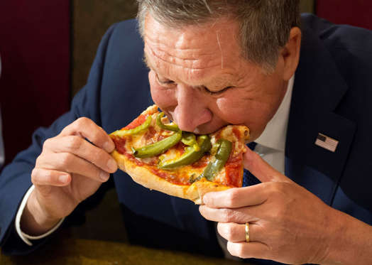 Republican presidential candidate, Ohio Gov. John Kasich eats pizza at Gino's Pizzeria, Wednesday, March 30, 2016, in the Queens borough of New York. The three Republican presidential candidates now say they aren't committing to supporting whomever the party chooses as its nominee for the November election, which could lead to a messy and fractured nominating convention in July. Mark Lennihan/AP