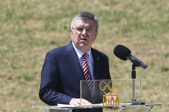 IOC President Thomas Bach delivers a speech during the ceremonial lighting of the Olympic flame.