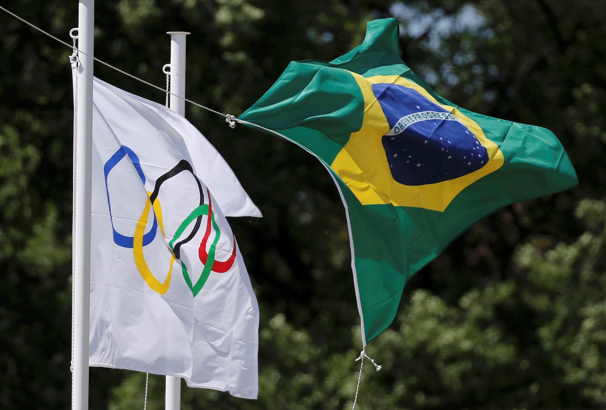 The Olympic and Brazilian flags fly over the site of ancient Olympia during the Olympic flame lighting ceremony in Greece.