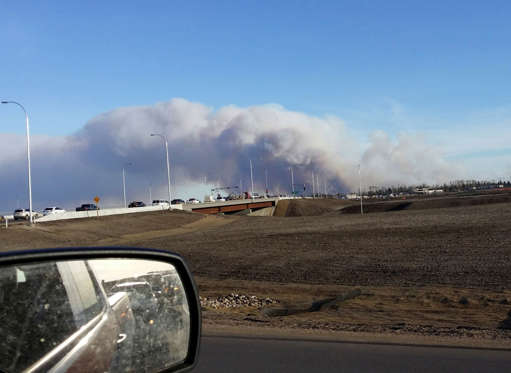 Vehicles are seen on highway 63 as they are detoured near wildfire burning near Fort McMurray, Alberta
