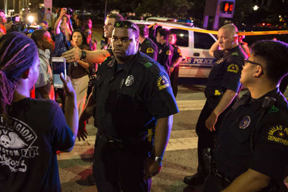 Police attempt to calm the crowd as someone is arrested following the sniper shooting in Dallas on July 7, 2016. A fourth police officer was killed and two suspected snipers were in custody after a protest late Thursday against police brutality in Dalla