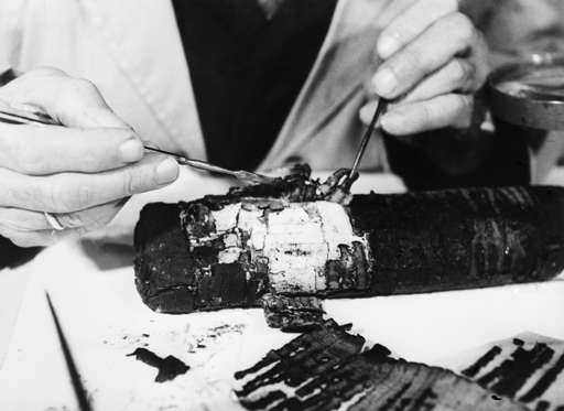 (Original Caption) Dead Sea Scrolls: An intricate and delicate operation in process of restoring Dead Sea Scrolls, is performed by Professor Bieberharant, in 1955, at the Israel Special Museum, House of the Book, Jerusalem, Israel. Undated photograph.