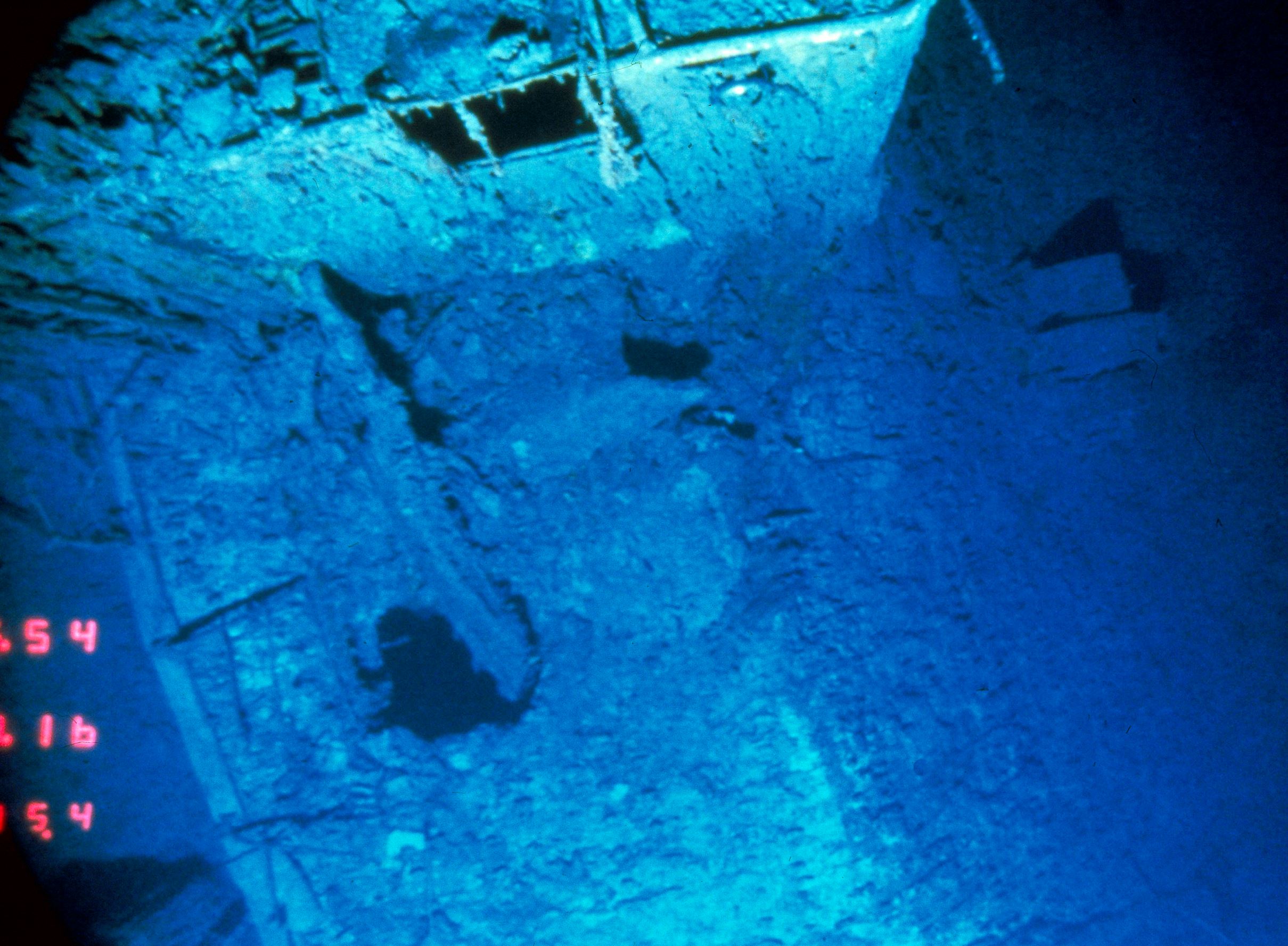 This is a view looking down on the deck of the R.M.S. Titanic between the number 2 and number 3 stack where the deck suddenly hinges downward at right towards the tear, at which point the stern separated from the rest of the ship. This picture was taken 