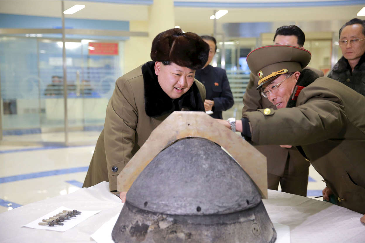 North Korean leader Kim Jong Un looks at a rocket warhead tip after a simulated test of atmospheric re-entry of a ballistic missile, at an unidentified location in this undated file photo released by North Korea's Korean Central News Agency (KCNA) in Pyongyang on March 15, 2016.