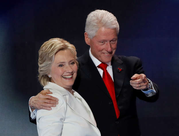 Democratic presidential nominee Hillary Clinton stands with her husband, former president Bill Clinton, after accepting the nomination on the final night of the Democratic National Convention in Philadelphia, Pennsylvania, U.S. July 28, 2016.