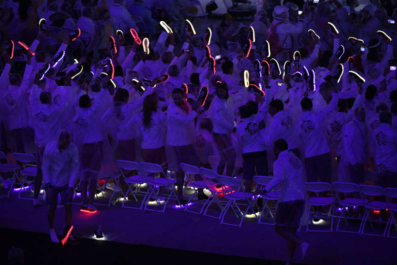 British athletes hold their illuminated "disco" shoes.