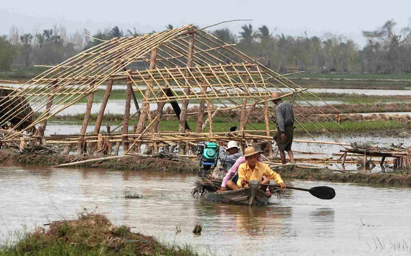 Aftermath of Cyclone Nargis, Burma - 10 May 2008 Villagers cross the flooded farmland on a boat on the outskirts of Yangon.