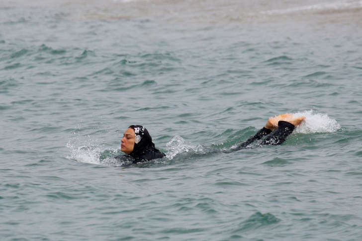 A Muslim woman wears a burkini, a swimsuit that leaves only the face, hands and feet exposed, as she swims in the Mediterranean Sea in Marseille, France, August 17, 2016.