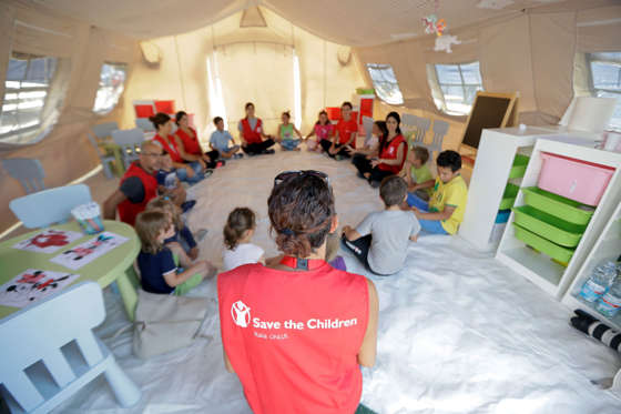 Children play in a tent set up for them by the 'Save the Children' humanitarian organization, in Amatrice.