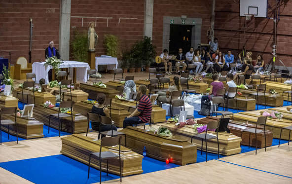 Coffins of some of the victims of the earthquake are seen inside a gym in Ascoli Piceno.