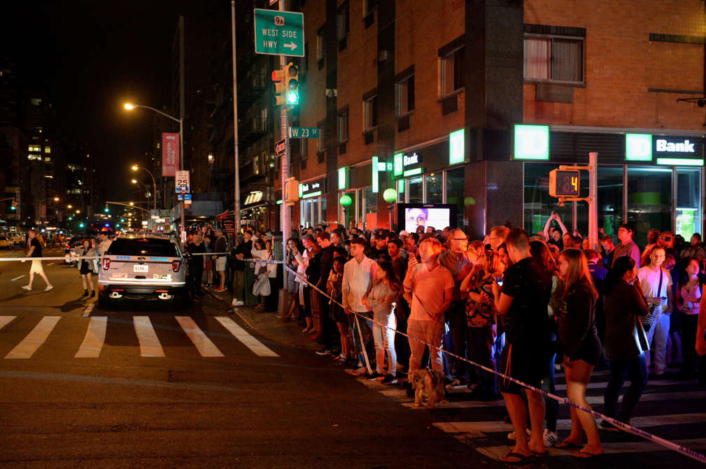 Onlookers stand behind a police cordon near the site of an explosion in the Chelsea neighborhood of Manhattan, New York, U.S. September 17, 2016.