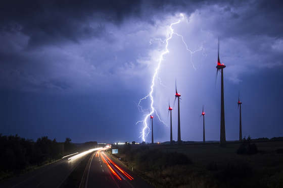 GOERLITZ, GERMANY - AUGUST 28: Lightning strikes behind wind turbines during a thunderstorm near the border between Germany and Poland on August 28, 2016 in Goerlitz, Germany. After a hot weekend across Germany, the weather is cooling down. (Photo by Flo