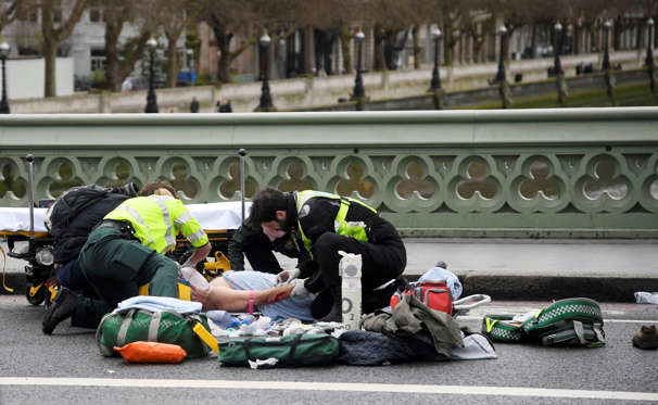 Slide 11 of 34: Paramedics treat an inured person after an incident on Westminster Bridge in London, March 22, 2017.