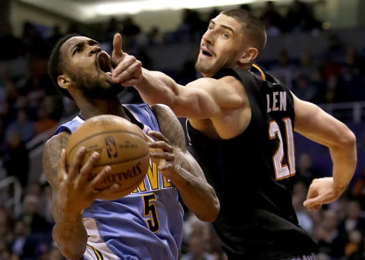 Slide 10 of 34: Denver Nuggets guard Will Barton (5) is fouled by Phoenix Suns center Alex Len in the first quarter during an NBA basketball game, Saturday, Jan. 28, 2017, in Phoenix. (AP Photo/Rick Scuteri)
