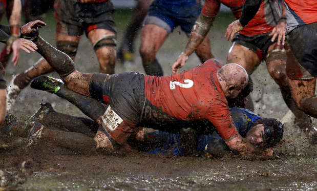 Slide 8 of 34: Newport Gwent DragonsAdam Hughes is tackled by Newcastle Falcons Scott Lawson during the Anglo-Welsh Cup match at Rodney Parade, Newport.