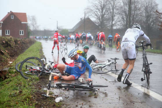 Slide 34 of 34: GHENT, BELGIUM - MARCH 01:  Riders crash in wet conditions during the Omloop Het Nieuwsblad on March 1, 2014 in Ghent, Belgium.  (Photo by Michael Steele - Velo/Getty Images)