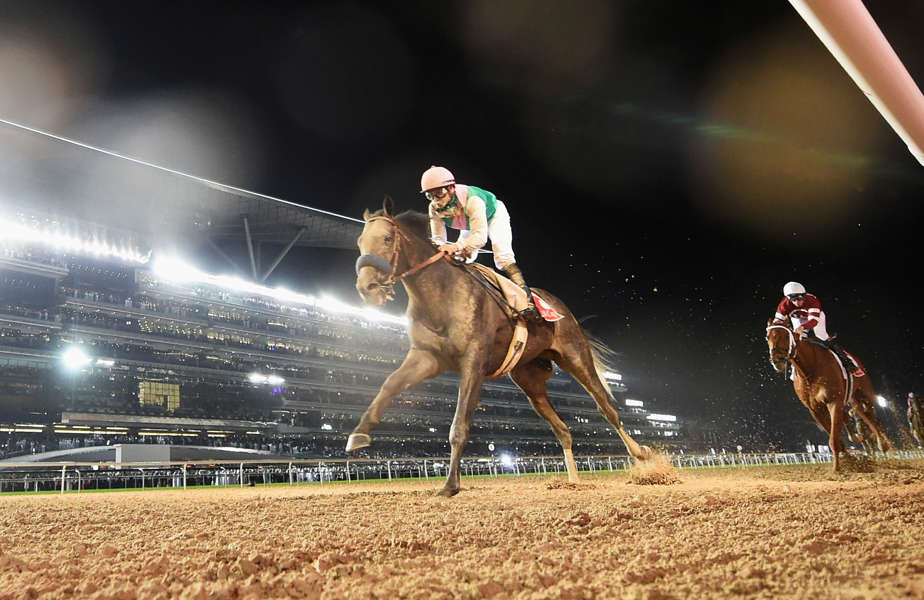 Mike Smith riding Arrogate wins the Dubai World Cup Sponsored By Emirates Airline during the Dubai World Cup at the Meydan Racecourse on March 25, 2017 in Dubai, United Arab Emirates.
