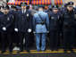 Law enforcement officers stand, with some turning their backs, as New York City Mayor Bill de Blasio speaks on a monitor outside the funeral for NYPD officer Wenjian Liu in the Brooklyn borough of New York January 4, 2015. Tens of thousands of law enforcement officers from across the country gathered on Sunday for the funeral of the second of two New York City policemen killed last month in an ambush that galvanized critics of Mayor de Blasio.