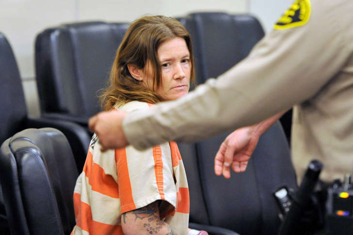 In this photo released by the Monterey County Weekly, Tami Huntsman is escorted out of Monterey County Superior Court following her arraignment Friday, Jan. 8, 2016, in Salinas, Calif. A California couple with 22 years of age between them appeared briefly in court to face charges they killed two of the woman's young children, stuffed their bodies in a plastic bin and stashed them in a rental storage unit. Huntsman, 39, and her 17-year-old companion appeared in court to be arraigned on first-degree murder charges for the deaths of Huntsman's 6-year-old daughter and 3-year-old son.
