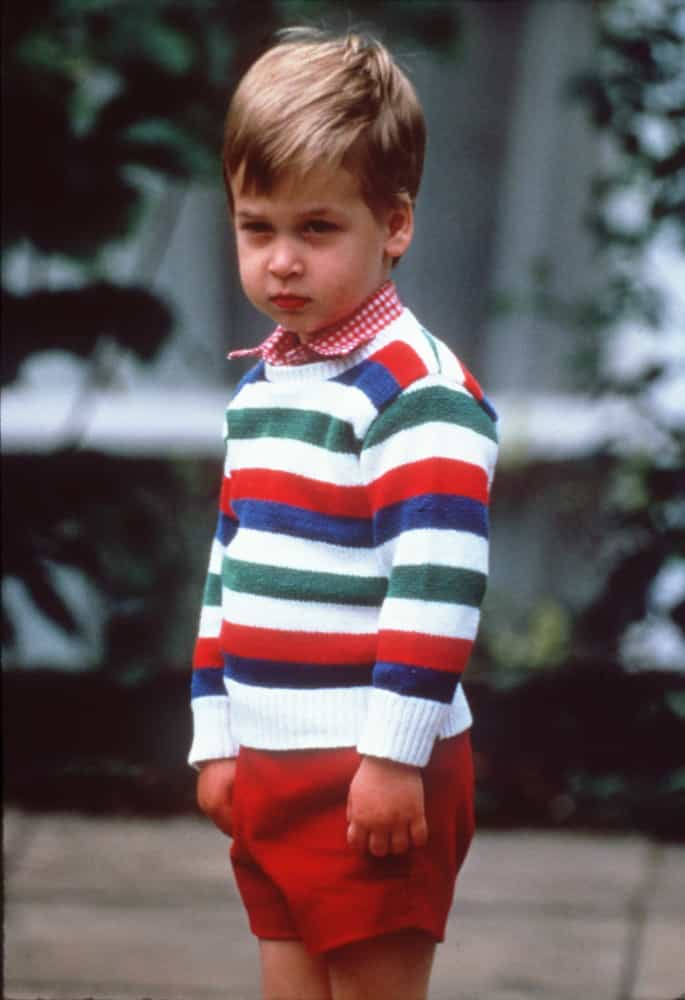 <p>A rather pensive-looking Prince William, wearing a striped jumper and red shorts, arrives for his first day at Mrs Mynor's Nursery School in Chepstow Villas, Notting Hill, London, on September 24, 1985.</p>