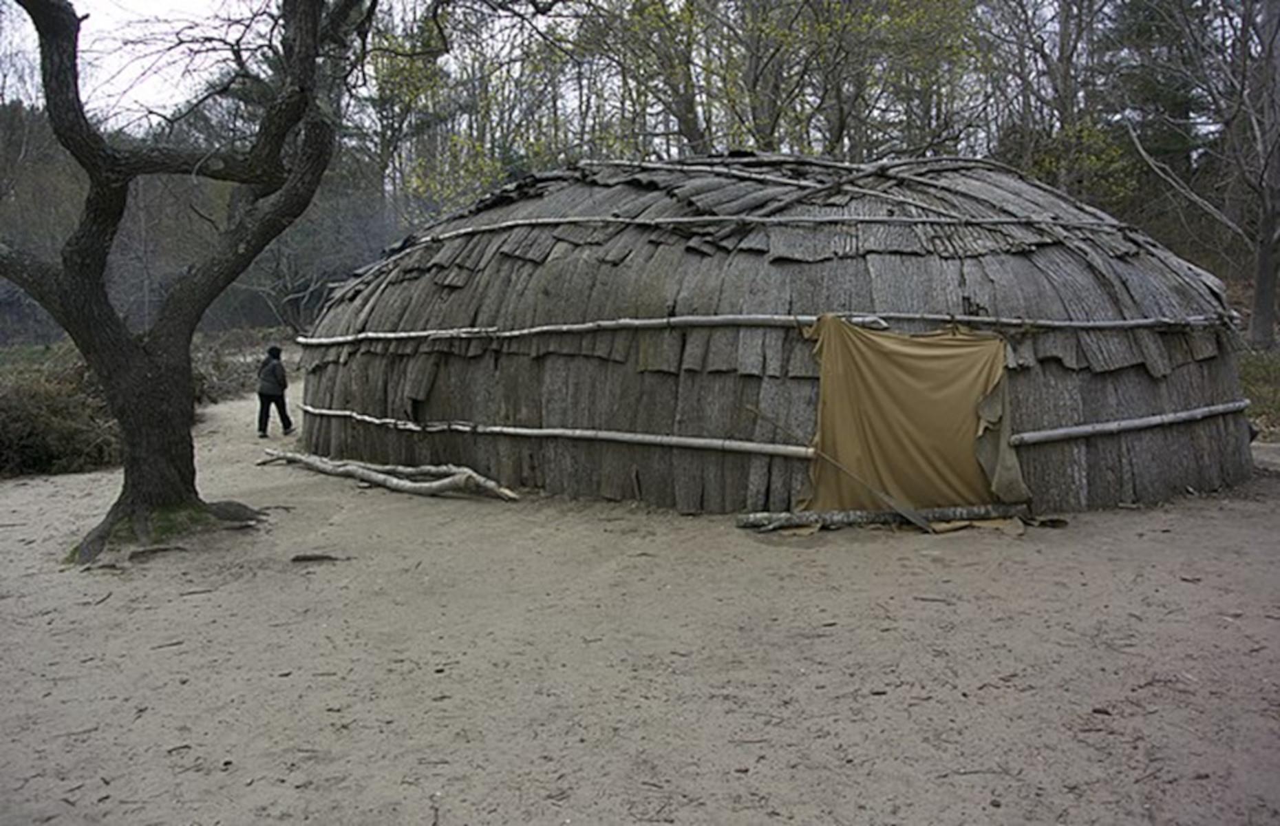 <p>However, before the colonists arrived in Massachusetts, the local Wampanoag people numbered between 50,000 and 100,000 across 67 different villages. Historic Patuxet is a recreation of a traditional Wampanoag village, consisting of a cooking area, fields of crops, and several <em>wetus</em>, or houses. Each <em>wetu</em> is lined with fur-laden benches where the villagers would gather around a fire for storytelling and song to pass the long winter nights and ward off the cold.</p>