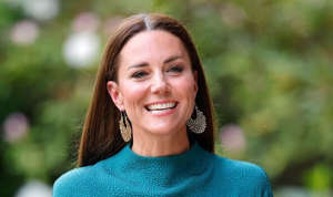 Kate smiling in a green gown 