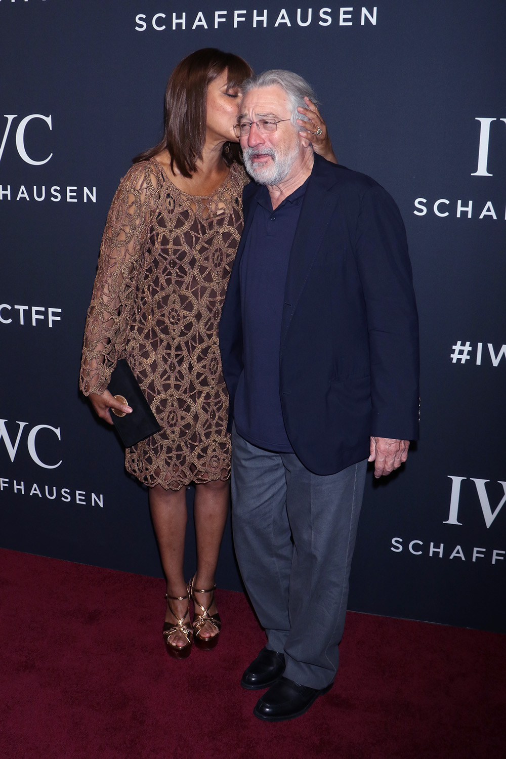 <p>Grace Hightower kissed her husband Robert De Niro’s head while walking the red carpet at an event. The actress sported a cutout brown dress for the evening.</p>
