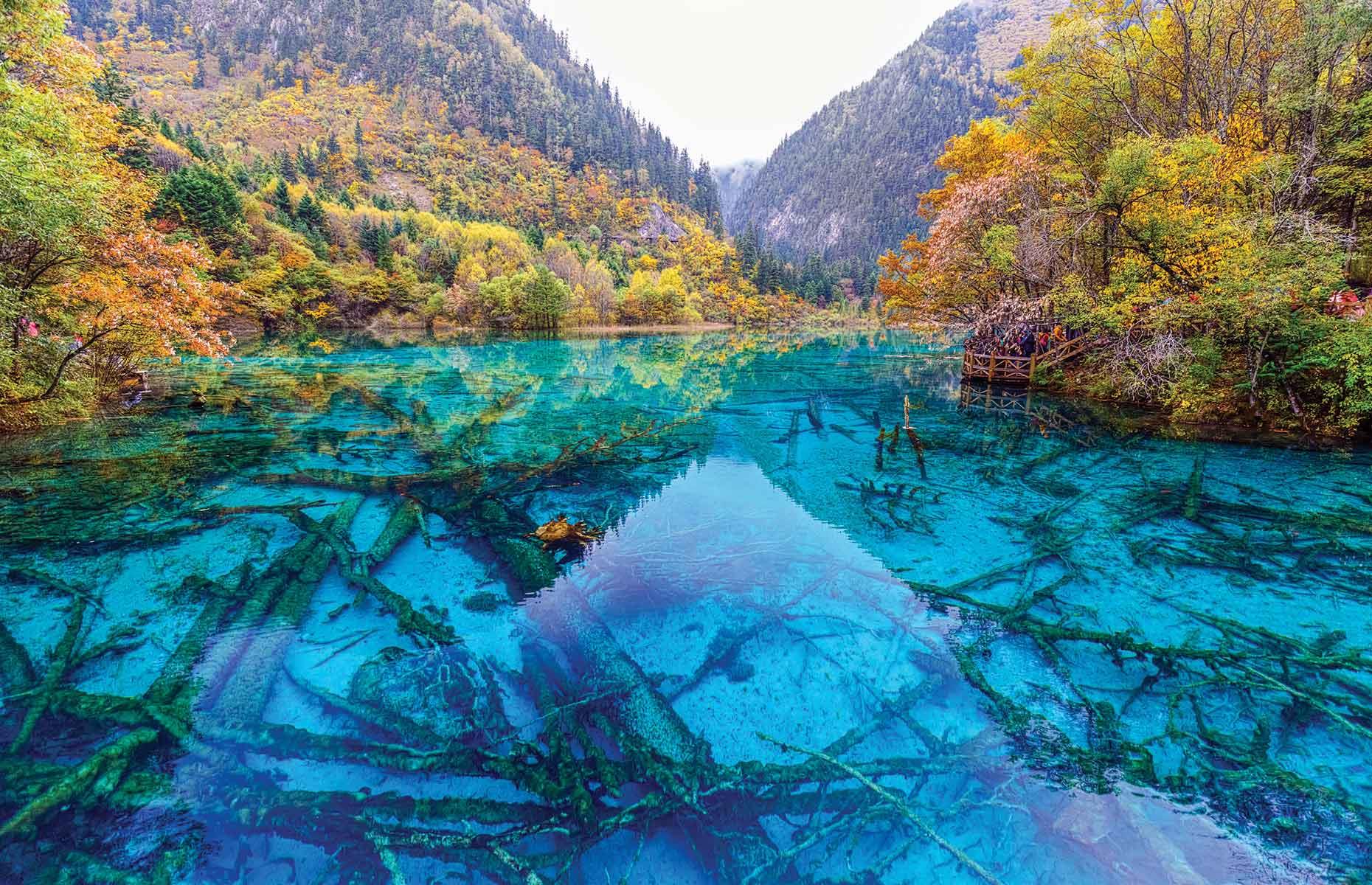 <p>Situated in the Min Mountains on the edge of the Tibetan Plateau in southwestern China, the Jiuzhaigou Nature Reserve is known for its hundred clear-water lakes, where mineral deposits color the water blue, green or turquoise. The jagged mountains are forested with a mix of broadleaf and coniferous trees. </p>