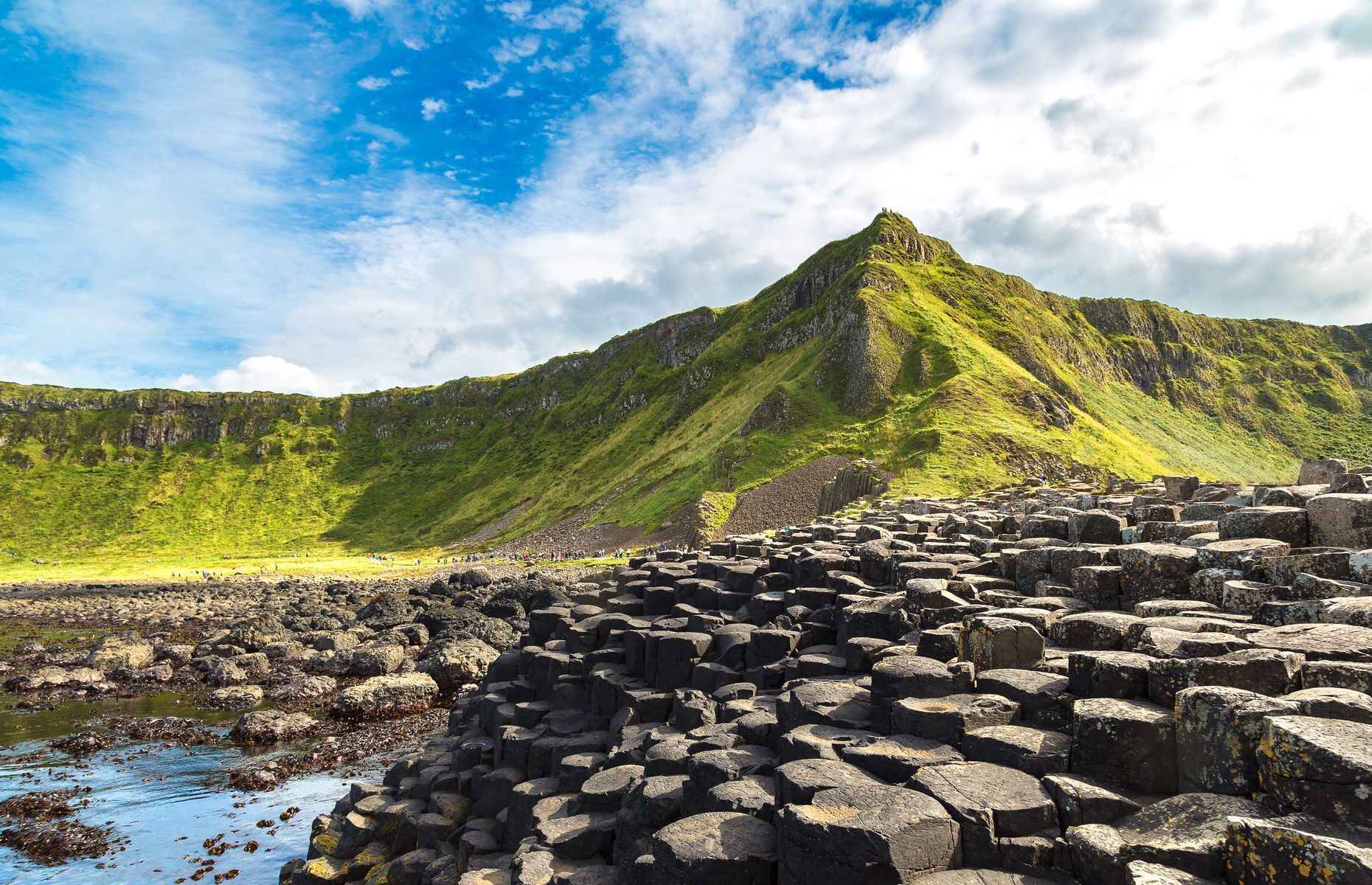 <p>If your trip includes a foray into Northern Ireland, be sure to stop by the <a href="https://www.ireland.com/en-us/things-to-do/attractions/giants-causeway/" rel="noreferrer noopener">Giant’s Causeway</a>. Listed as a UNESCO World Heritage Site, this impressive volcanic formation is made up of more than 40,000 interlocking basalt columns and has been fascinating tourists from all over the world.</p>