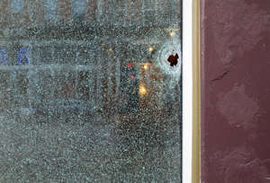 A bullet shatters a window on Main Street at 13th in Over-the-Rhine, Sunday, August 7, 2022. Overnight, there was a mass shooting leaving nine people injured. The shooting started at Mr. PitifulÕ', just across the street.