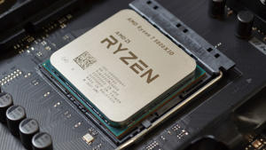 An AMD <a href="https://www.geekinco.com/2022/06/ryzen-7-5800x3d-delid-works-wonders.html">Ryzen 7 5800X3D</a> processor seated into a black motherboard