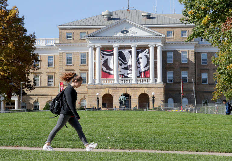 A student walks to class past Bascom Hall at the University of Wisconsin Madison on Wednesday, Oct. 23, 2019.