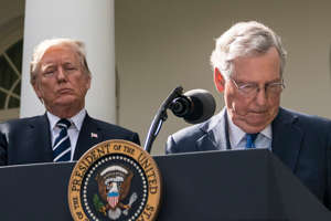 Then-Senate Majority Leader Mitch McConnell (R-Ky.) speaks at an event in the Rose Garden of the White House with President Donald Trump behind him in 2017.