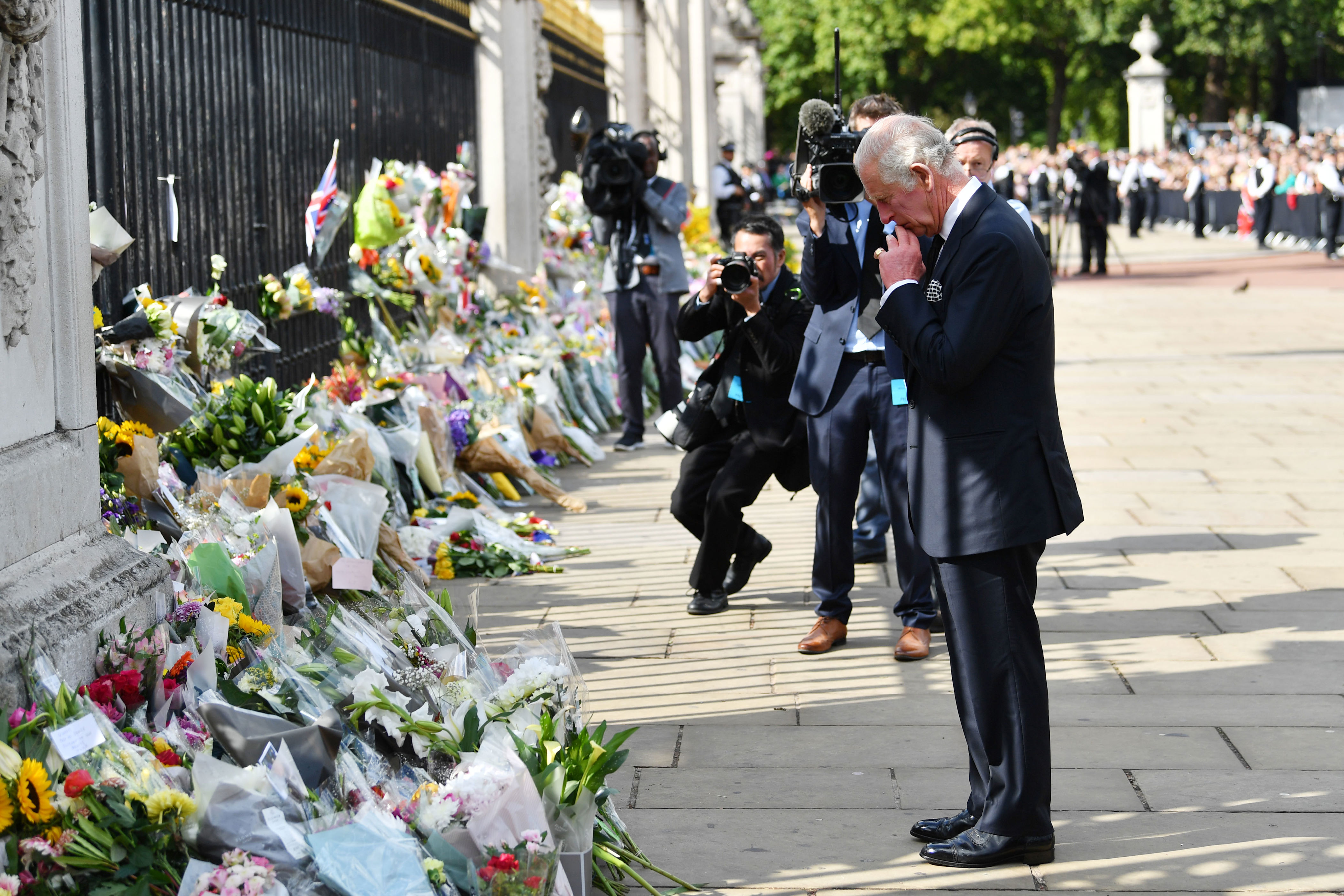 <p>A grieving King Charles III took a moment to reflect on the thousands of floral tributes left for his mother, Queen Elizabeth II, outside the gates of Buckingham Palace in London on Sept. 9, 2022, the morning after <a href="https://www.wonderwall.com/celebrity/celebrities-dignitaries-react-to-death-of-queen-elizabeth-ii-647756.gallery">the monarch died in Scotland</a>.</p>