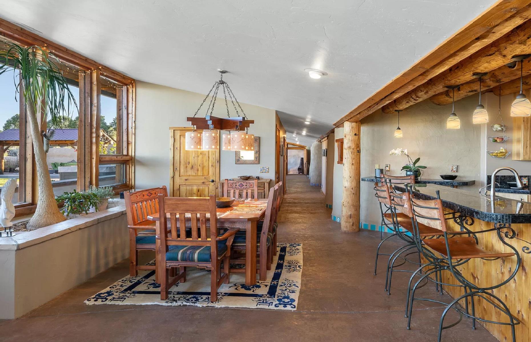 <p>We adore the home's rustic ceiling beams, oversized windows, sleek walls and floors, handmade kiva fireplaces, and quirky tiled details. Almost every window benefits from <a href="https://www.loveproperty.com/gallerylist/72934/homes-with-jaw-dropping-views">jaw-dropping views</a> of the Grand Mesa to the north, sweeping across the Cimarron Ridge all the way to the Sneffels Range in the south. Just picture pulling up a chair at the dining table and enjoying your morning eggs with this specular landscape right outside.</p>
